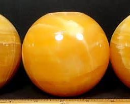 Orange Calcite Tea Light Candle Holder in the shape of a ball or sphere